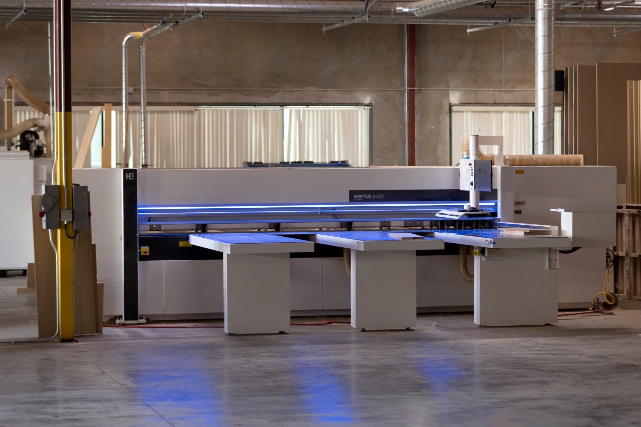 Stacked premium wood panels in ABBS Cabinets production facility