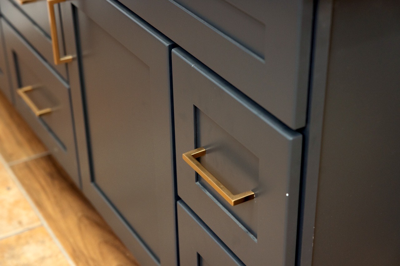 Walk-in closet with dark cabinets